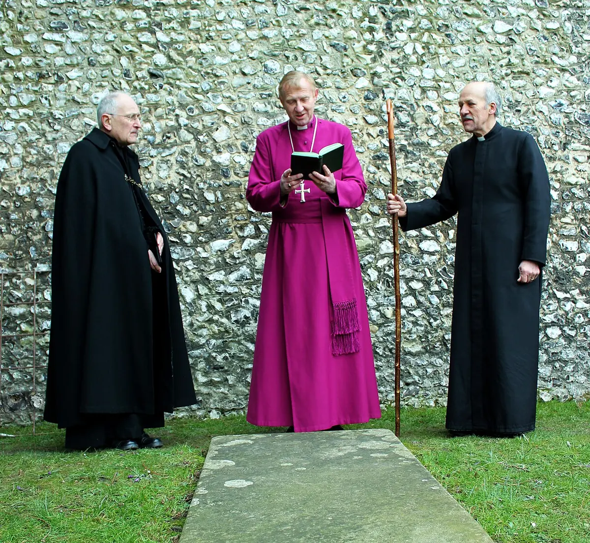Prayers being led on the unmarked grave suspected to be that of Alfred the Great. Image: Diocese of Winchester.