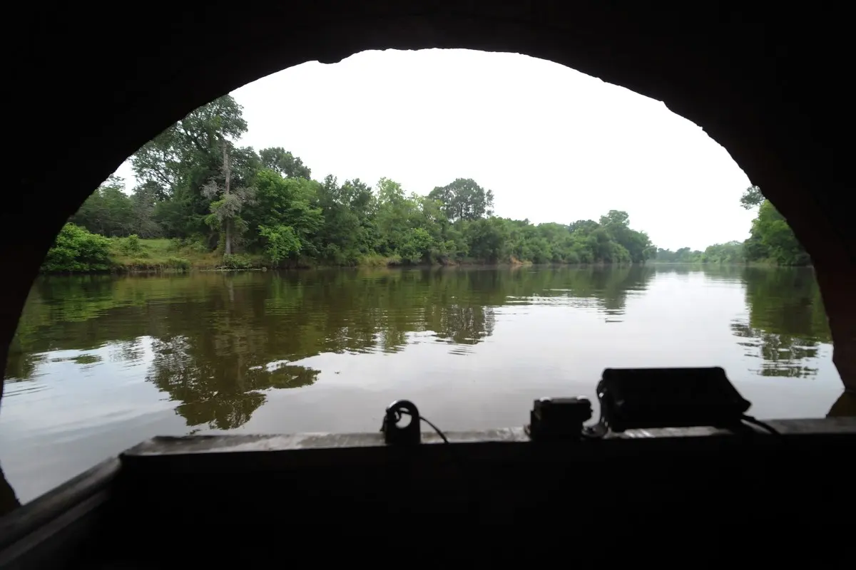 An iron culvert set in a man-made dike allows water, aquatic life and fishermen to pass on the Cutoff, also known as Creslenn Lake, on May 27, 2024.