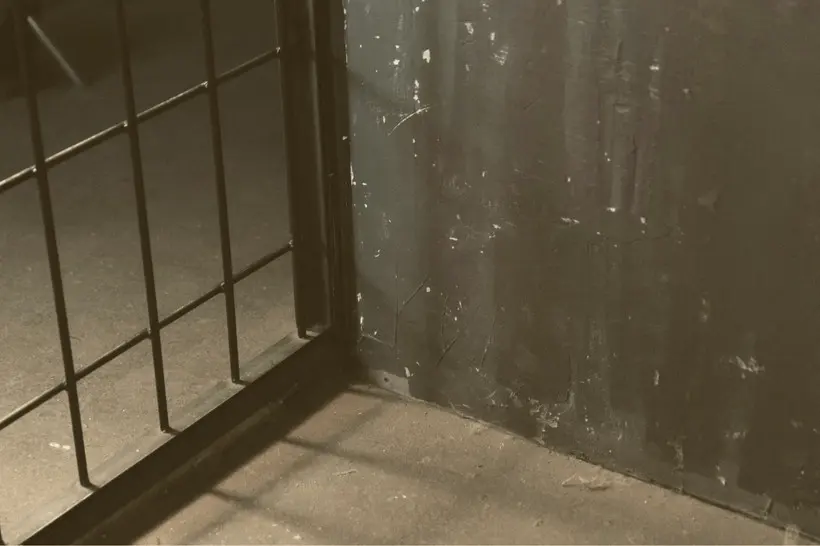Close-up of the corner of a prison cell.