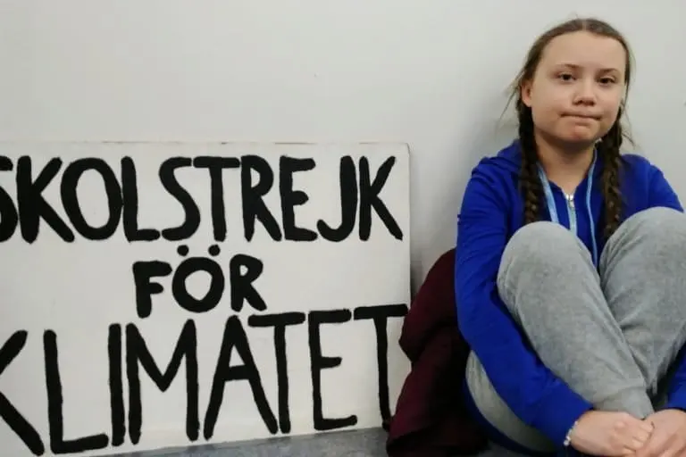 Greta Thunberg founded the school strike movement in 2018 at age 15 out of her frustration with the lack of response by the world’s nations to the climate emergency. Here, she sits in protest on the final day of the U.N. climate talks in Katowice, Poland in 2018 (COP24). Thunberg attended COP26 but was given no role there by authorities. Image by Hans Nicholas Jong / Mongabay.