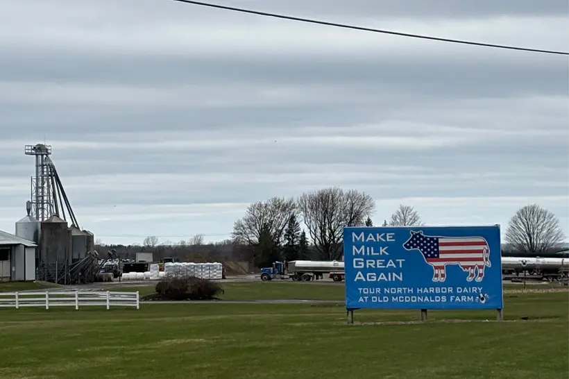 A sign in front of Old McDonald's dairy farm, where federal immigration enforcement agents detained three children and their mother last month. | Julia Rock