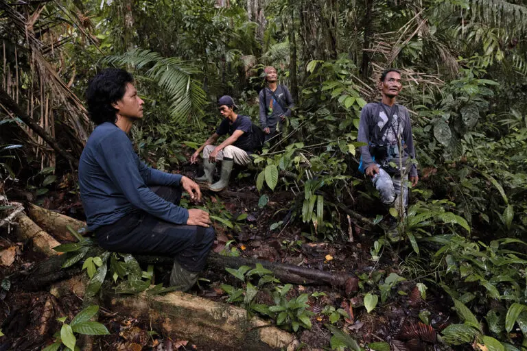 Members of Malinggai Uma Tradisional Mentawai, a grassroots, Indigenous-led conservation organization, takes a break during a forest patrol, South Siberut, Indonesia. Image by Ana Norman Bermudez for Mongabay.