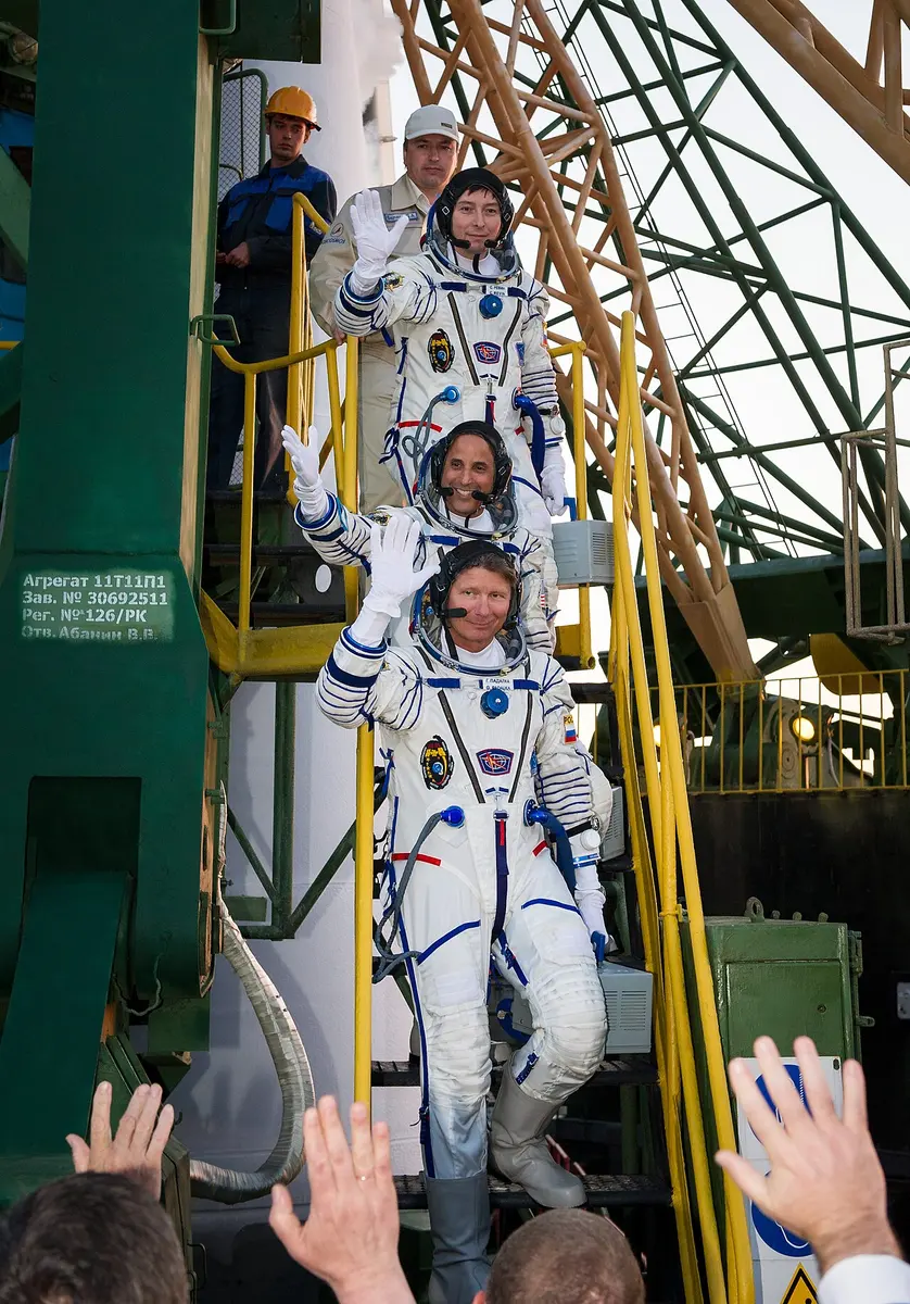 The crew of Soyuz TMA-04M wave to spectators before boarding their International Space Station-bound rocket Tuesday. Image: NASA/Bill Ingalls.