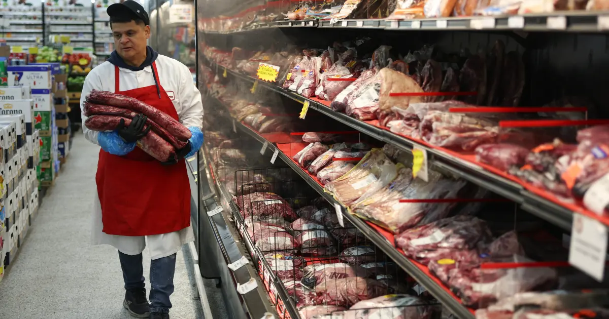 A worker in a meat section of a grocery store Credit: Joe Raedle/Getty Images via Sentient.