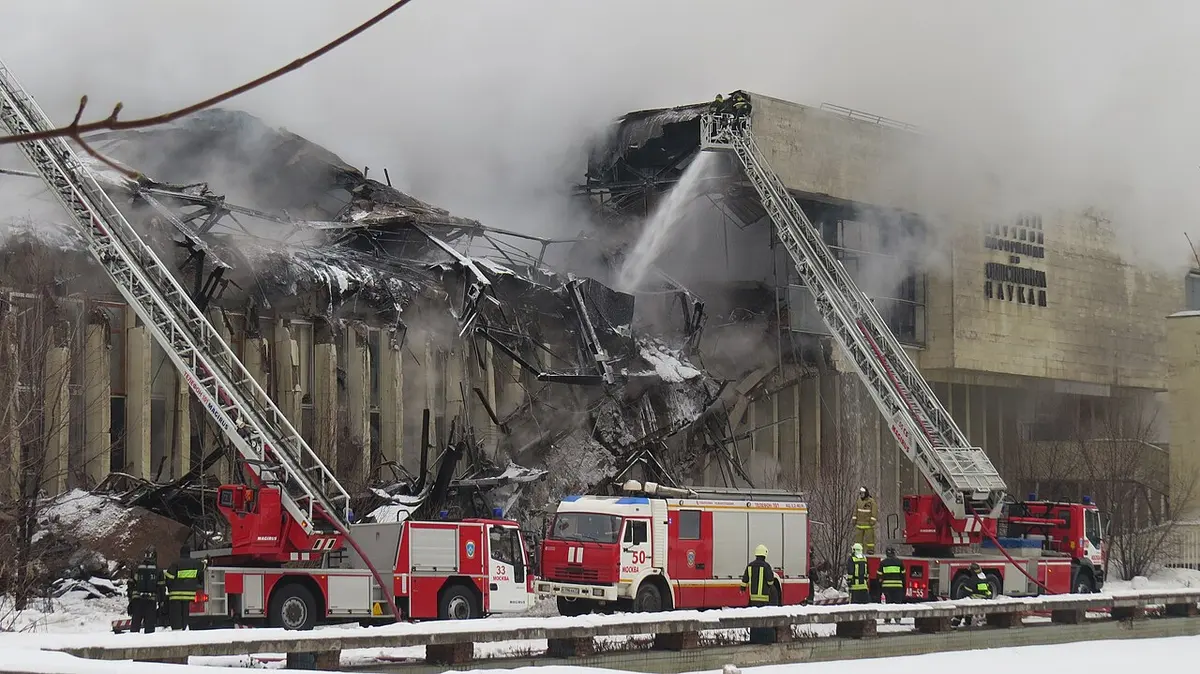 Firefighters in front of the partially destroyed building.Image: Sergey Leschina.