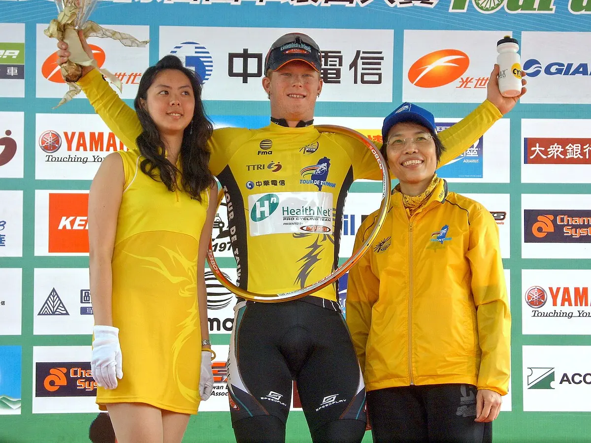 John Murphy (center), a yellow jersey leader, with one of the Miss Ettiquettes.Image: Rico Shen.