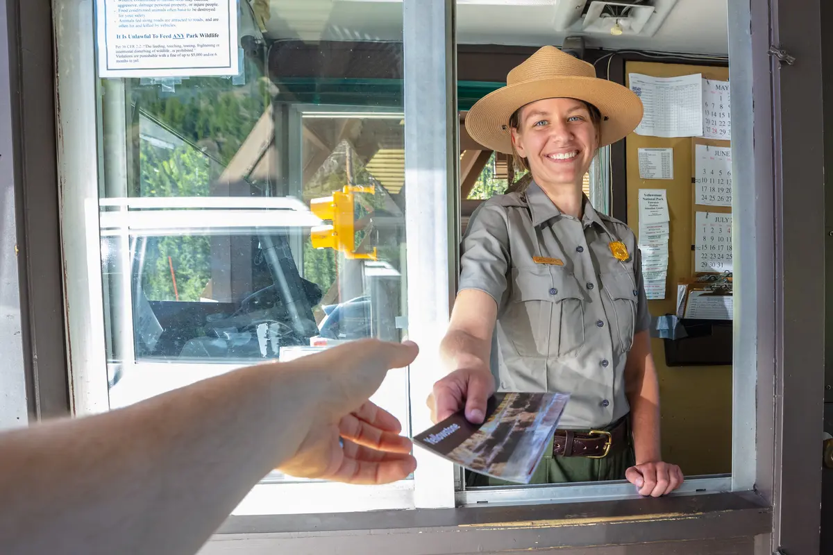 Ranger at East Entrance hands out a park map NPS / Jacob W. Frank