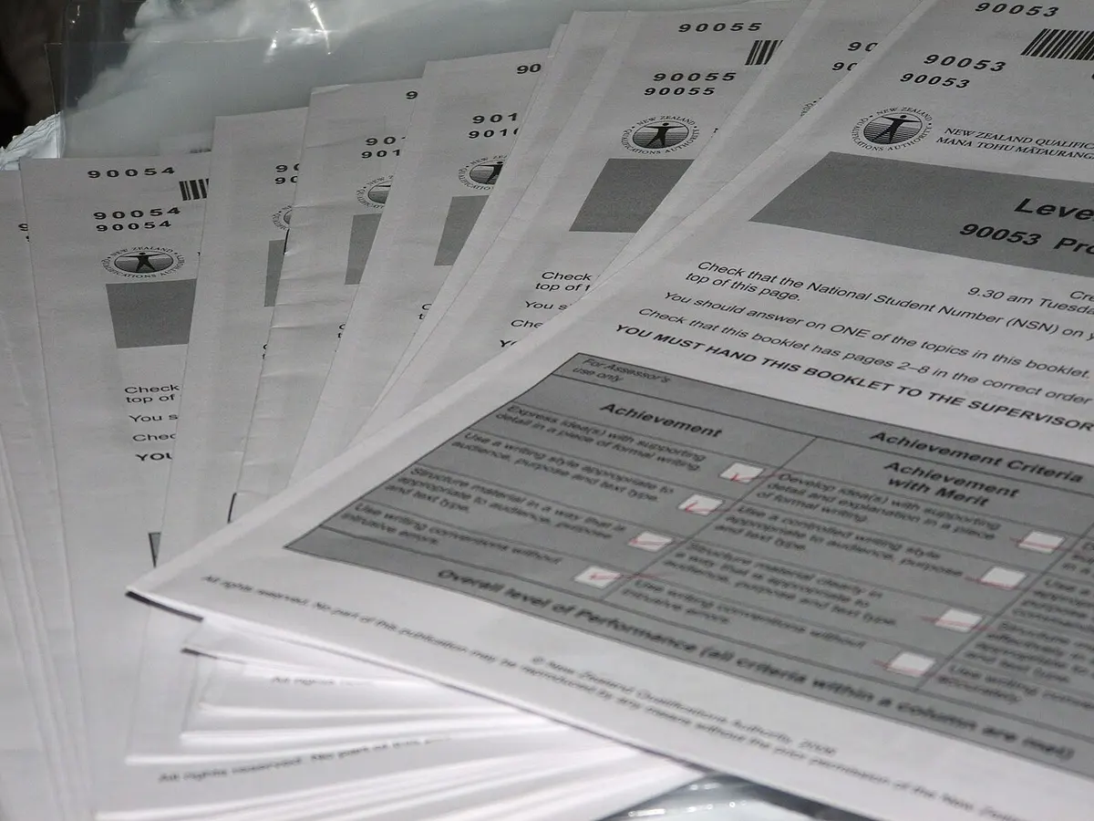 A pile of returned and marked NCEA exam booklets. Photograph by Gabriel Pollard.