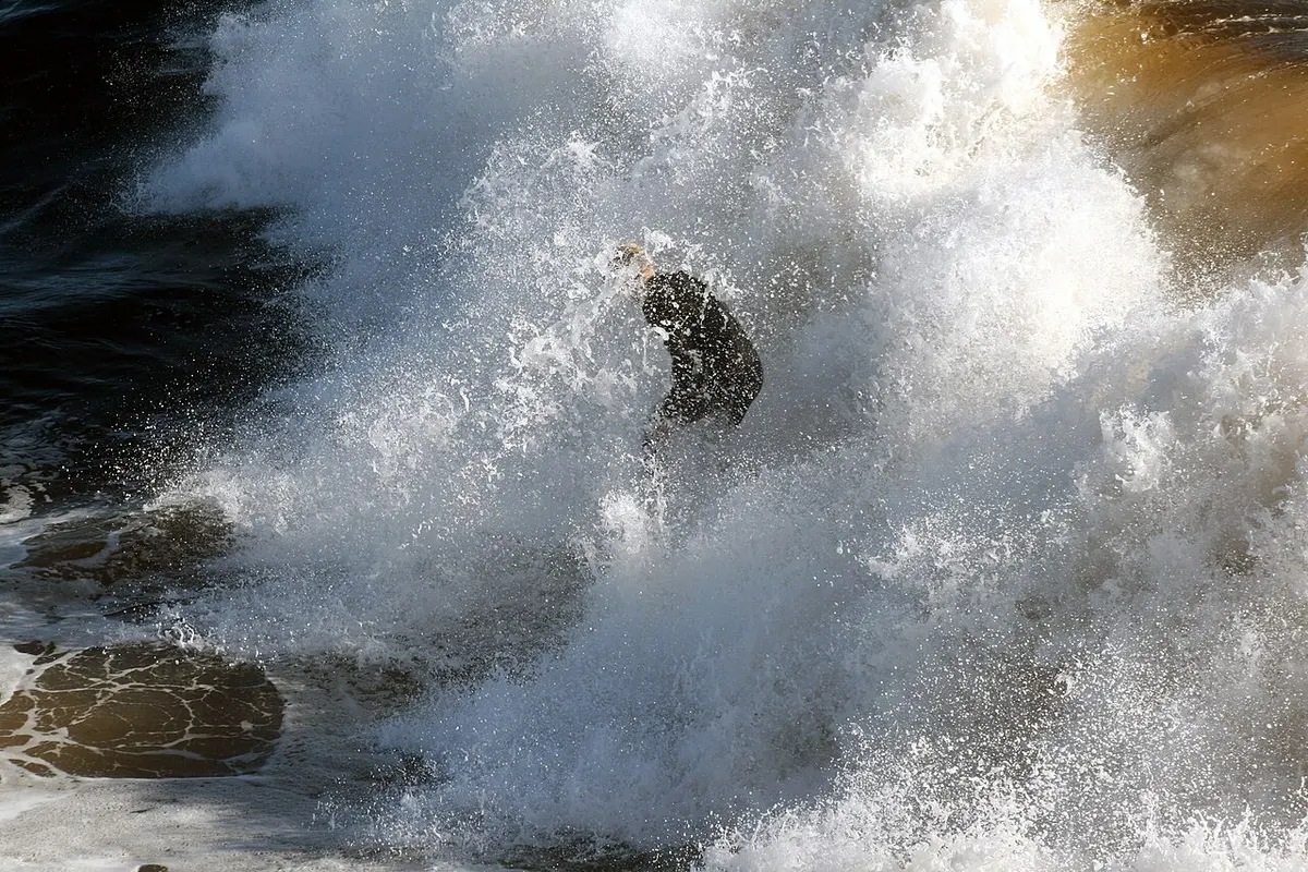 A surfer in northern California being sprayed with seawater. One study showed that surfers swallow much more seawater than swimmers.Image: TheBrockenInaGlory.