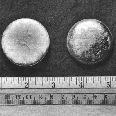 Plutonium pictured against an inch and centimeter rule. Image: United States Department of Energy.
