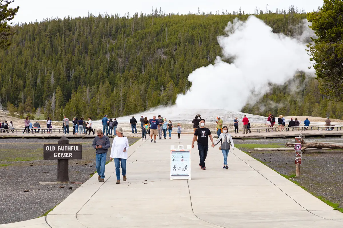 Visitors leaving the Old Faithful boardwalks after an eruption Opening Day NPS/Jacob W. Frank