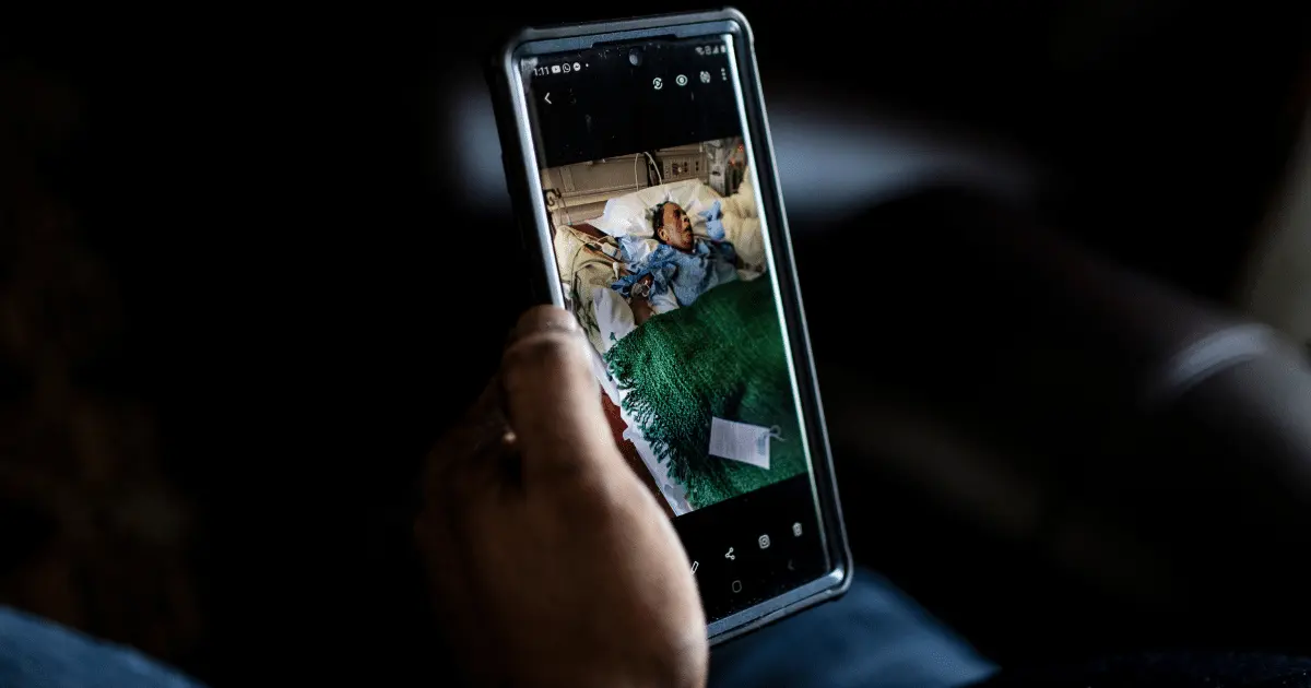 A person holding up a picture on their phone Credit: Chet Strange for The Washington Post via Getty Images via Sentient.