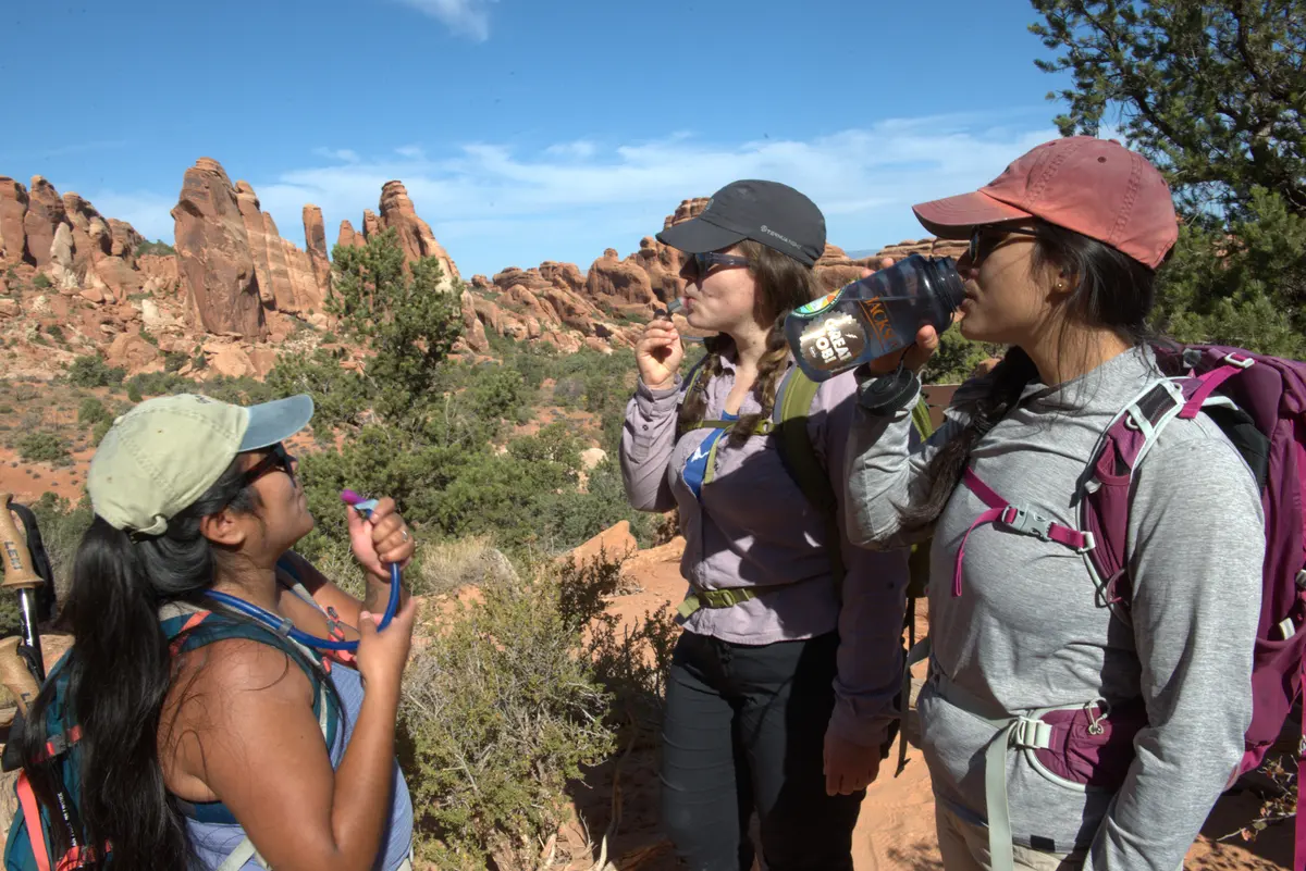 A group of hikers stop to hydrate along the Devils Garden Trail in Arches National Park NPS/Veronice Verdin