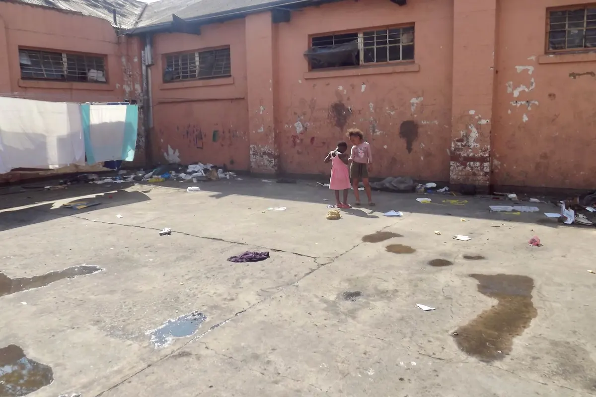 Children play in a filthy area at Struben No 2 Shelter.