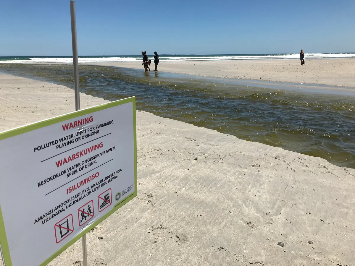 Signs at the mouth of the Milnerton Lagoon, which is highly polluted, warn against swimming or coming into contact with the water. But these signs are often not seen or ignored. Archive photo: Steve Kretzmann